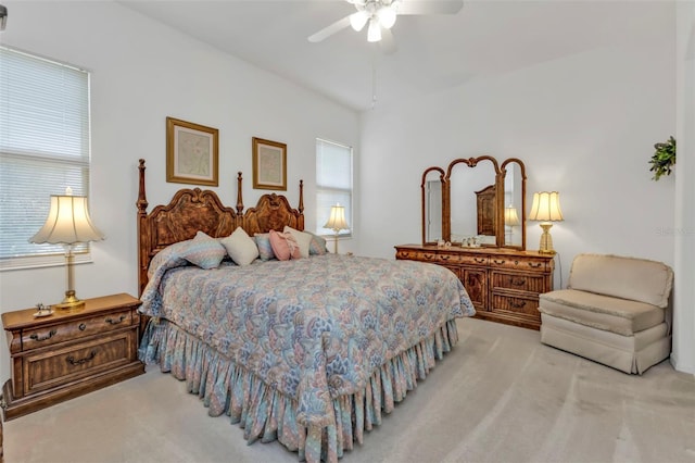 bedroom featuring a ceiling fan and light colored carpet