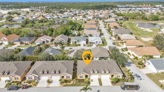 birds eye view of property featuring a water view and a residential view