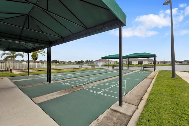 view of home's community featuring fence, shuffleboard, a lawn, and a gazebo