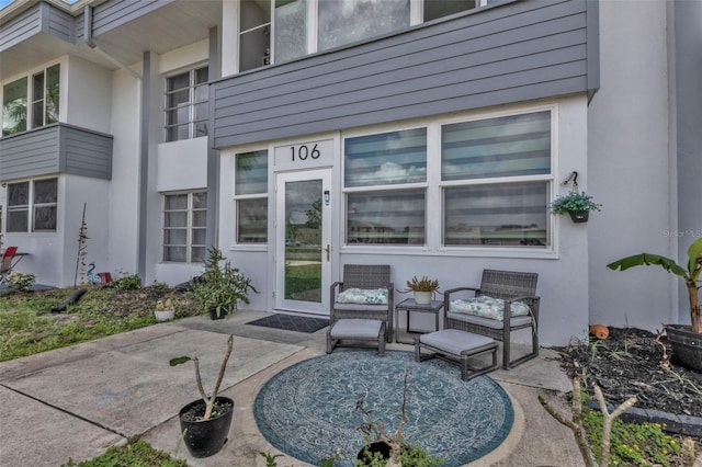 property entrance featuring a patio area and stucco siding