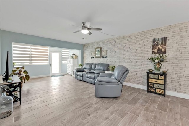 21287 Gertrude Ave Unit 106, Port Charlotte, FL 33952 - living room with a ceiling fan, wood tiled floor, baseboards, and brick wall
