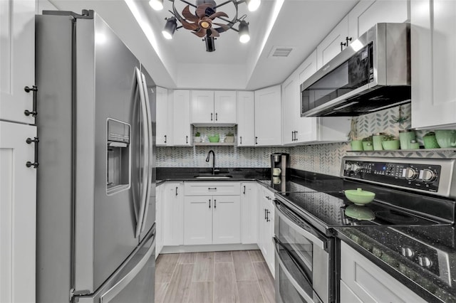 21287 Gertrude Ave Unit 106, Port Charlotte, FL 33952 - kitchen with tasteful backsplash, visible vents, appliances with stainless steel finishes, white cabinets, and a sink