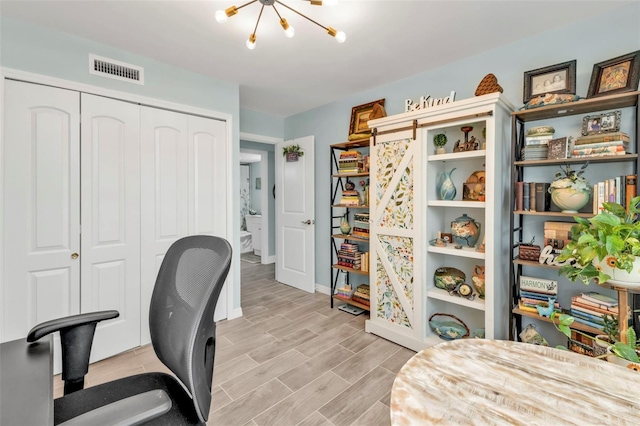 21287 Gertrude Ave Unit 106, Port Charlotte, FL 33952 - home office with a chandelier, wood finish floors, visible vents, and baseboards