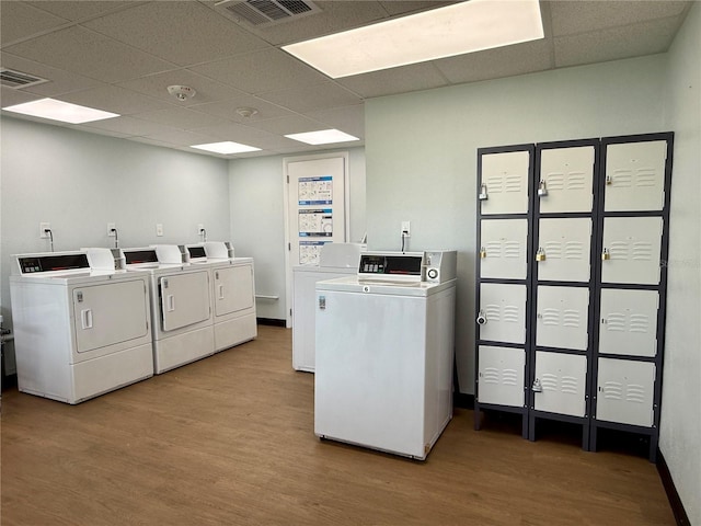 21287 Gertrude Ave Unit 106, Port Charlotte, FL 33952 - shared laundry area featuring wood finished floors, washing machine and dryer, and visible vents