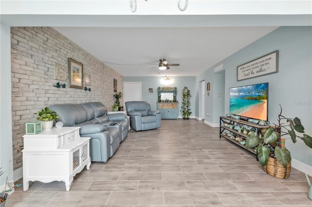 21287 Gertrude Ave Unit 106, Port Charlotte, FL 33952 - living room with brick wall, visible vents, ceiling fan, and baseboards