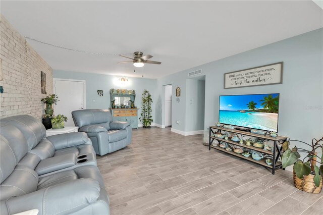 21287 Gertrude Ave Unit 106, Port Charlotte, FL 33952 - living area with ceiling fan, brick wall, visible vents, baseboards, and light wood finished floors