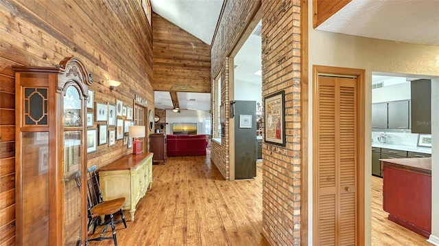 interior space with light wood-style flooring, visible vents, and high vaulted ceiling