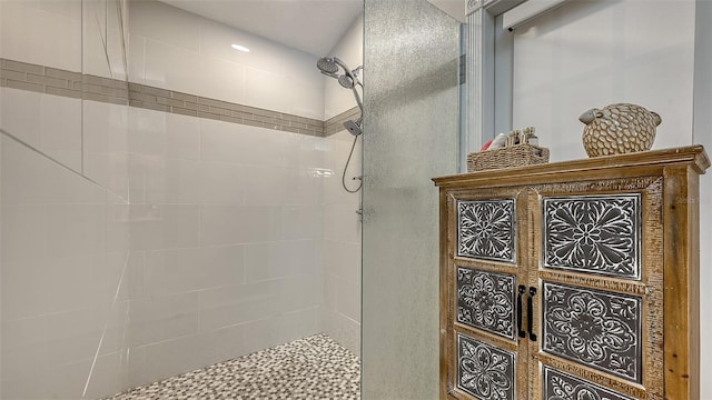 full bath with a tile shower