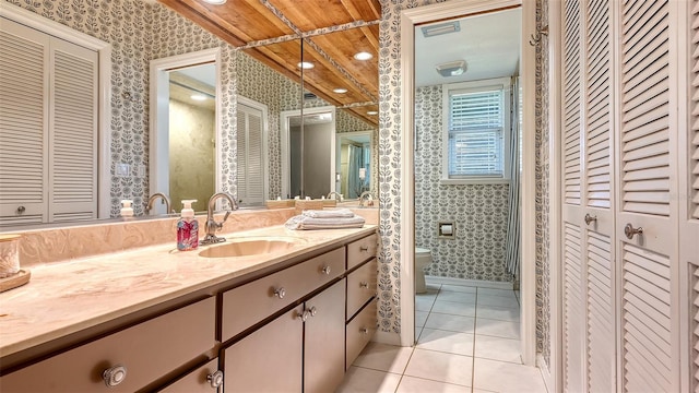 full bath featuring toilet, wallpapered walls, tile patterned flooring, and a closet