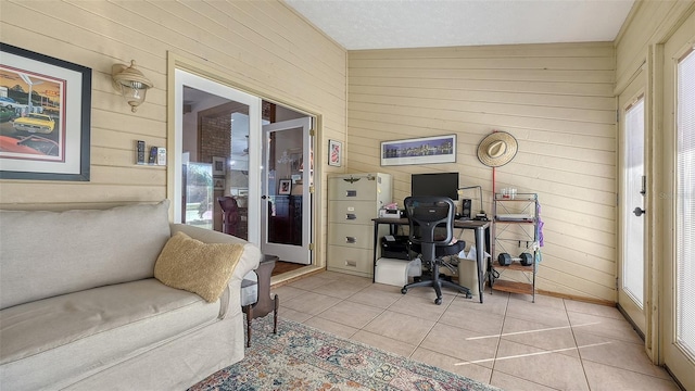 office space featuring wooden walls and light tile patterned flooring