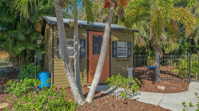 view of outdoor structure with an outbuilding and fence