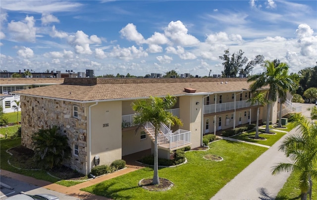3136 Harbor Blvd Unit 1A, Port Charlotte, FL 33952 - exterior space with stone siding, a front lawn, and stucco siding