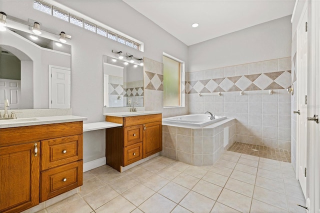 bathroom featuring vanity, independent shower and bath, and tile patterned flooring