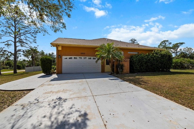 view of front of house featuring a front yard and a garage