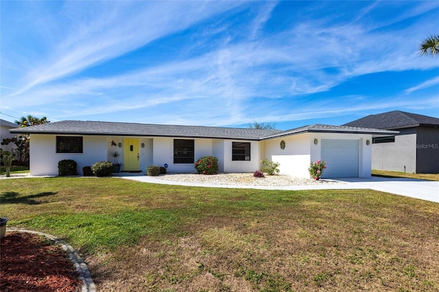 ranch-style home featuring a garage, a front yard, concrete driveway, and stucco siding