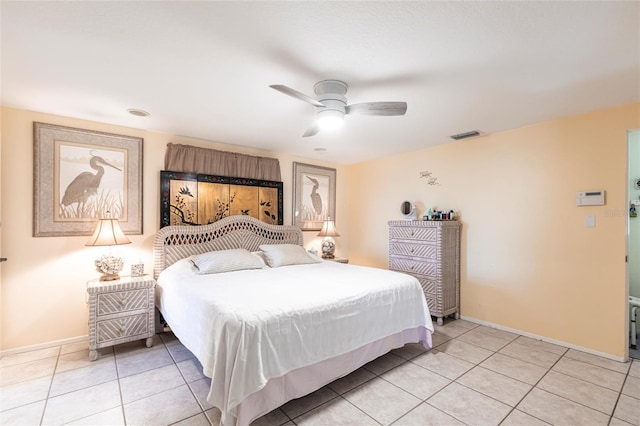 bedroom with light tile patterned floors, visible vents, a ceiling fan, and baseboards