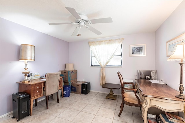 office featuring light tile patterned floors, a ceiling fan, and baseboards