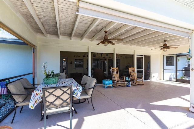 view of patio featuring outdoor dining area and a ceiling fan
