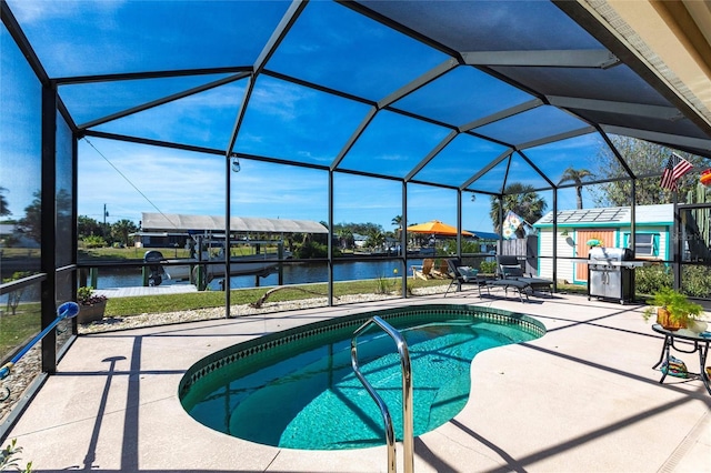 outdoor pool featuring a patio, grilling area, a water view, and a lanai