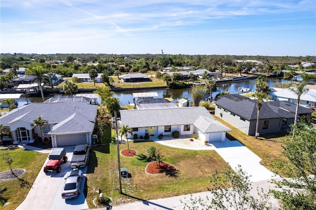 drone / aerial view with a residential view and a water view