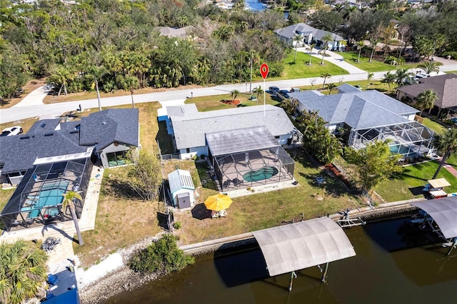 drone / aerial view featuring a water view and a residential view