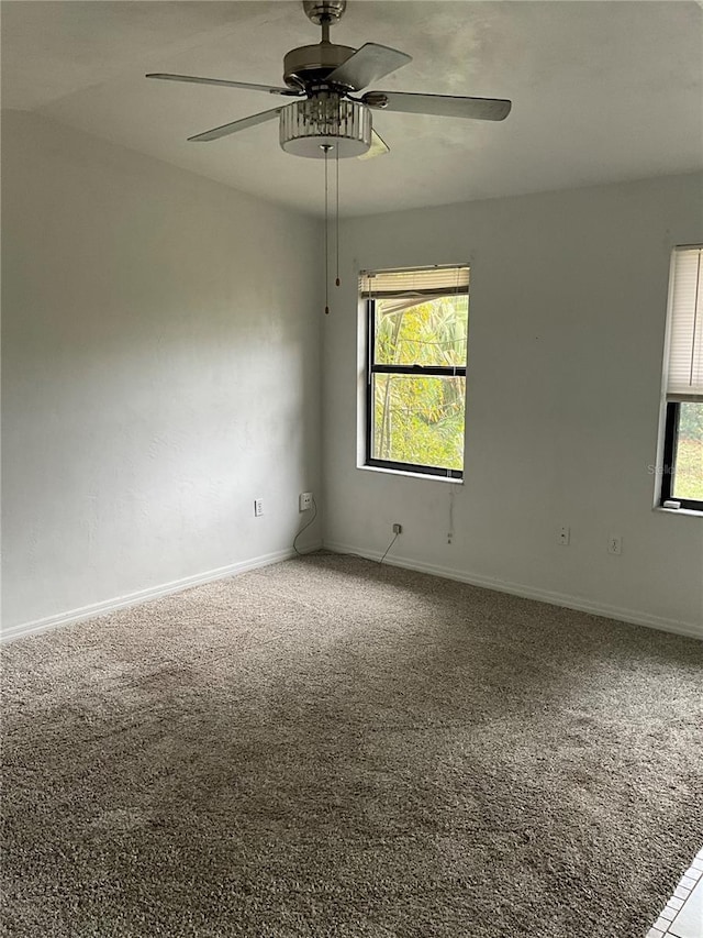 unfurnished room with carpet and ceiling fan