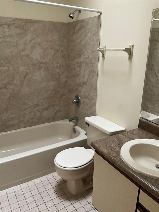 full bathroom featuring toilet, vanity, tile patterned flooring, and tiled shower / bath combo