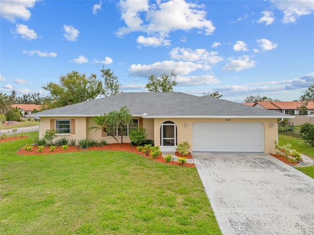 ranch-style house featuring a garage, a front yard, concrete driveway, and stucco siding