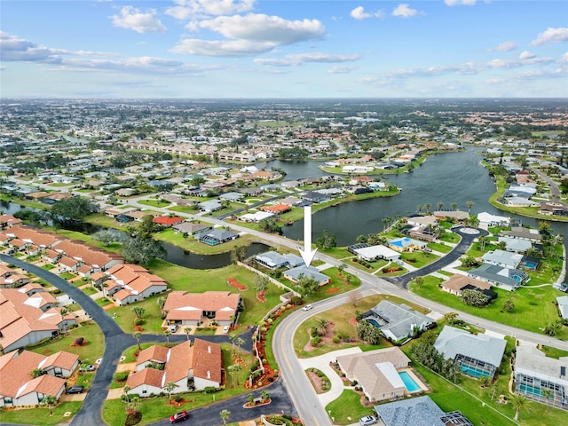 drone / aerial view featuring a residential view and a water view