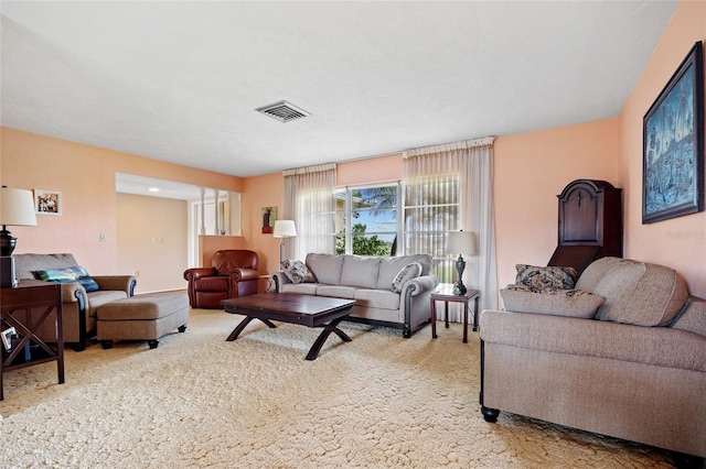 living room with visible vents and light colored carpet