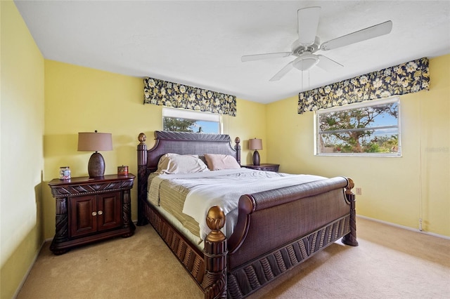 bedroom featuring light carpet, ceiling fan, and baseboards