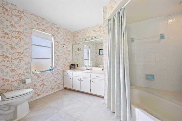 bathroom with toilet, vanity, baseboards, shower / bath combo with shower curtain, and wallpapered walls