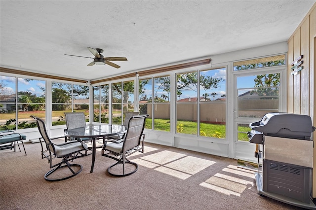 sunroom / solarium featuring ceiling fan