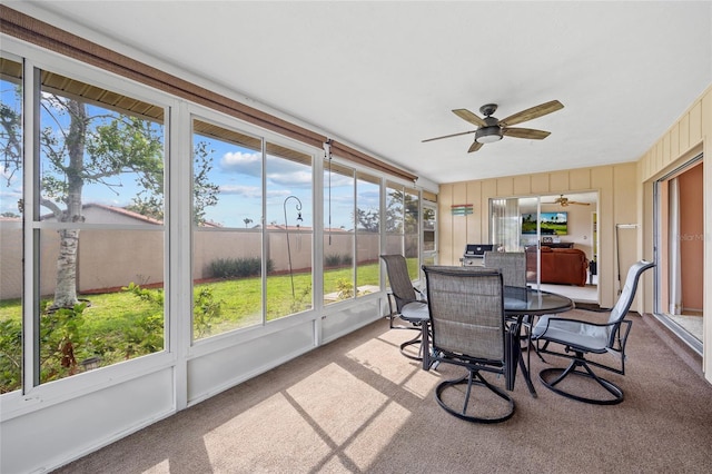 sunroom / solarium featuring ceiling fan