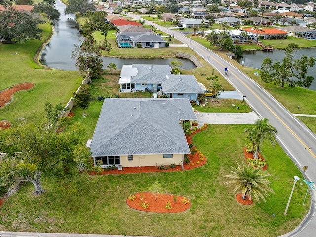 bird's eye view with a water view and a residential view