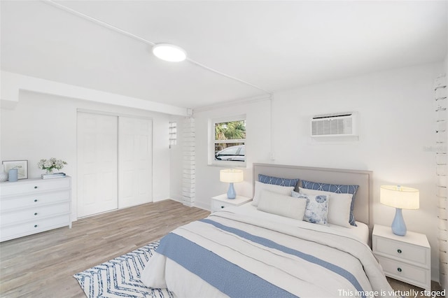 23475 Harper Ave, Port Charlotte, FL 33980 - bedroom featuring wood finished floors, a closet, and an AC wall unit