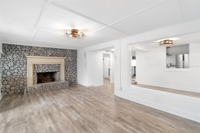 23475 Harper Ave, Port Charlotte, FL 33980 - unfurnished living room with wood finished floors, baseboards, and a stone fireplace