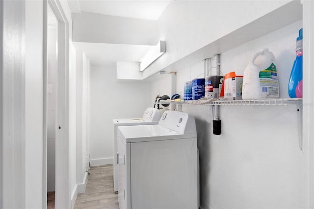 23475 Harper Ave, Port Charlotte, FL 33980 - washroom featuring independent washer and dryer, light wood-type flooring, and baseboards