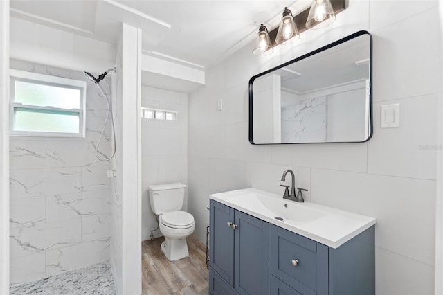 23475 Harper Ave, Port Charlotte, FL 33980 - full bathroom with tile walls, vanity, wood finished floors, a marble finish shower, and toilet