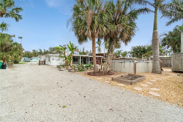 23475 Harper Ave, Port Charlotte, FL 33980 - view of front of home featuring driveway and a sunroom