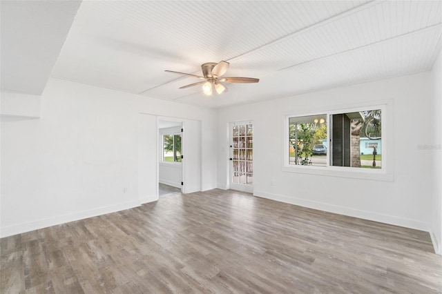 23475 Harper Ave, Port Charlotte, FL 33980 - unfurnished room with a ceiling fan, wood finished floors, and baseboards