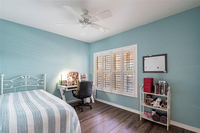 bedroom featuring dark wood-style floors, a ceiling fan, and baseboards