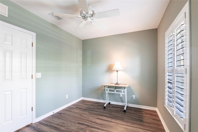 office area with ceiling fan, dark wood finished floors, visible vents, and baseboards