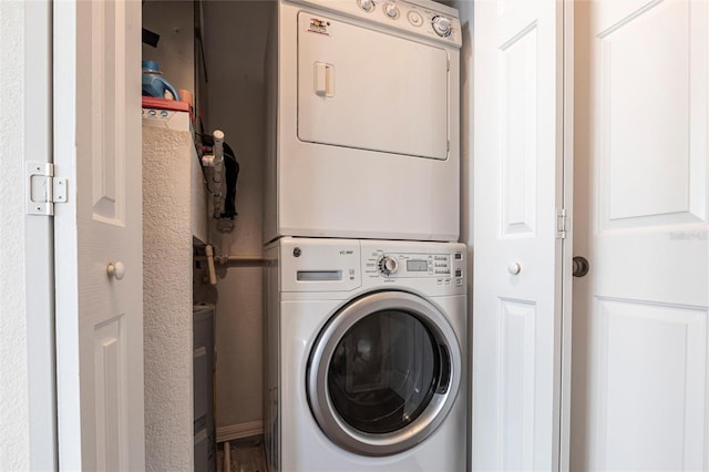 laundry area featuring stacked washing maching and dryer and laundry area