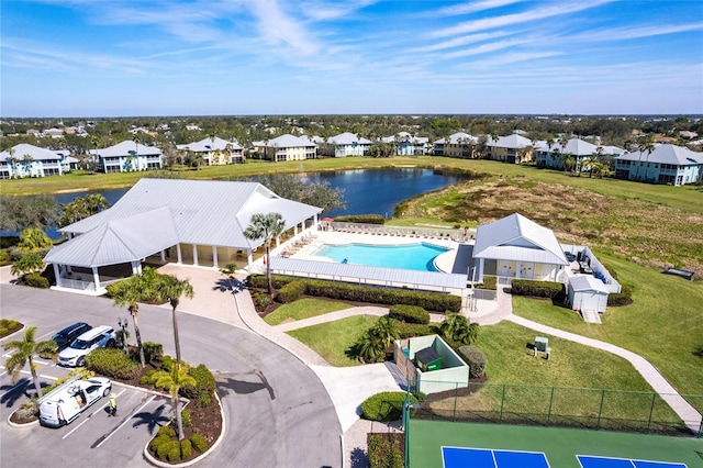 birds eye view of property featuring a water view and a residential view