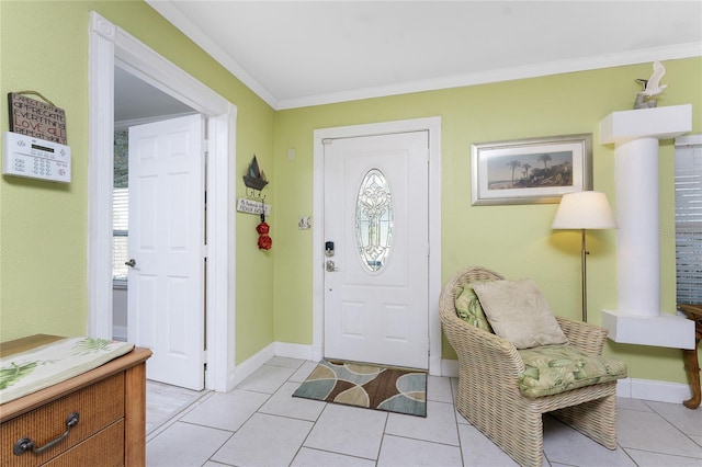 entrance foyer with light tile patterned floors, baseboards, and ornamental molding