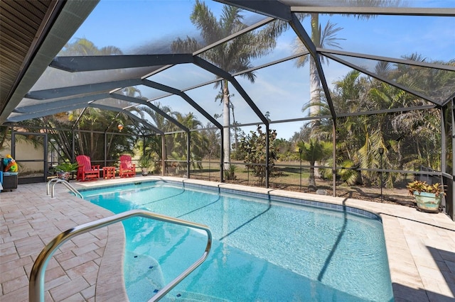 outdoor pool featuring glass enclosure and a patio area