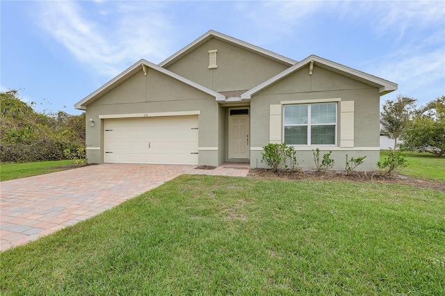 ranch-style house with decorative driveway, an attached garage, a front yard, and stucco siding