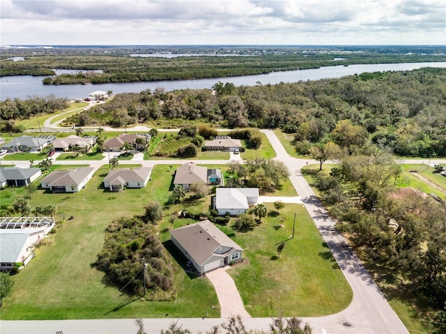 birds eye view of property featuring a residential view, a water view, and a view of trees