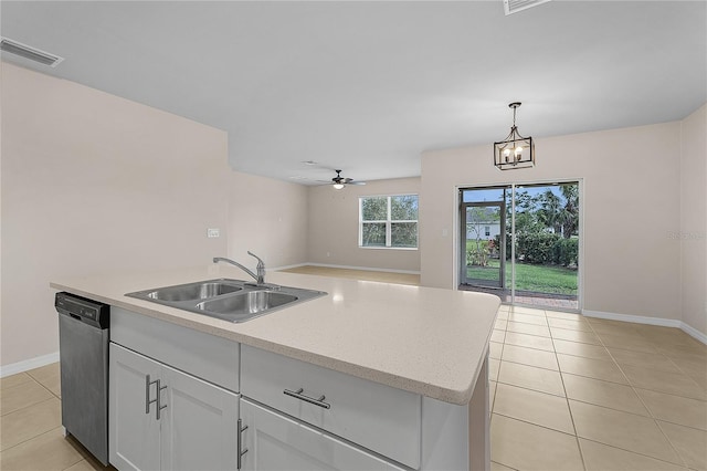 kitchen featuring a center island with sink, dishwasher, open floor plan, pendant lighting, and a sink